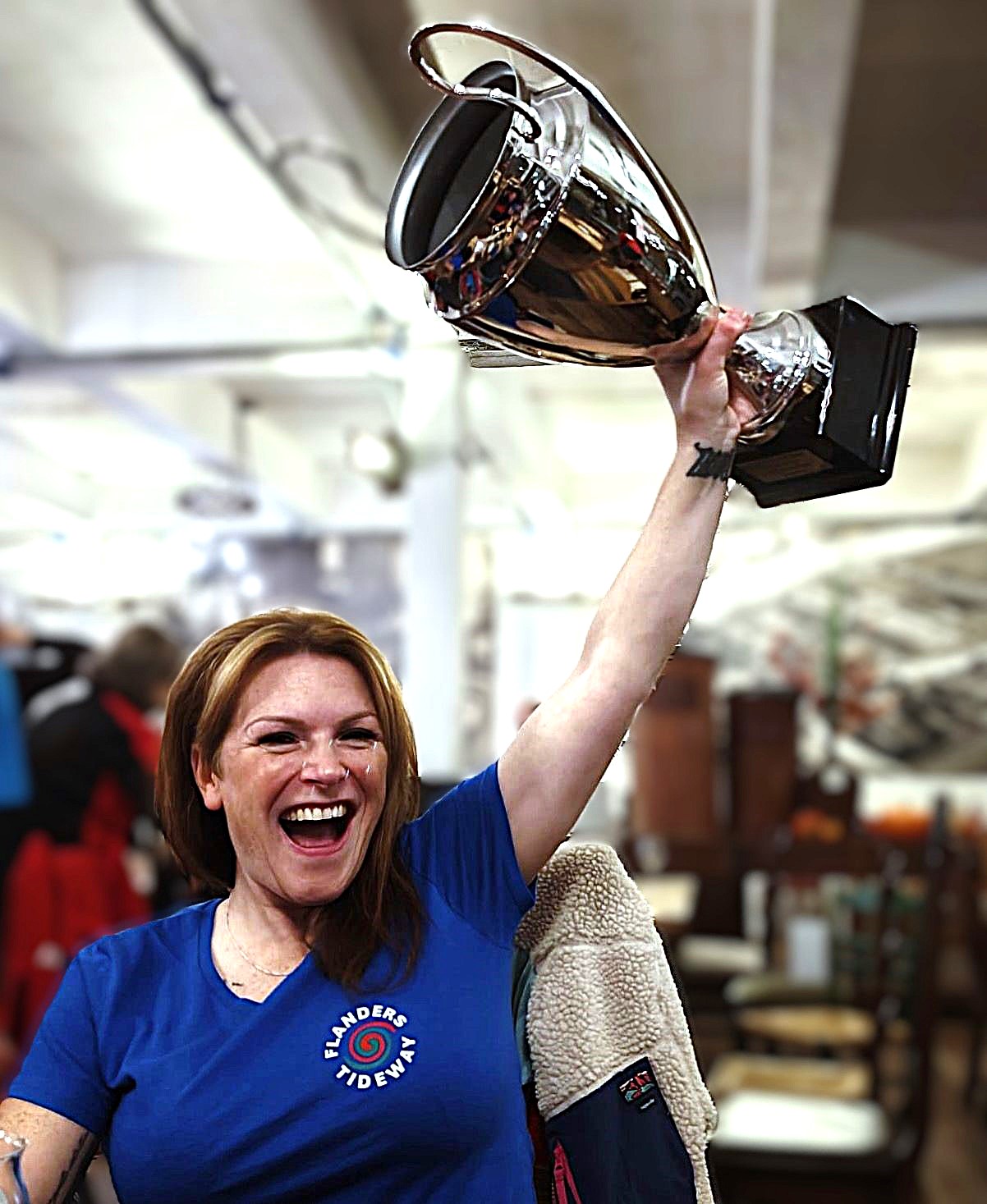 Hannah Moneagle lifts up the Flanders Tideway III Participants Challenge Cup for the United Scottish Highlands St Ayles Skiff Crews